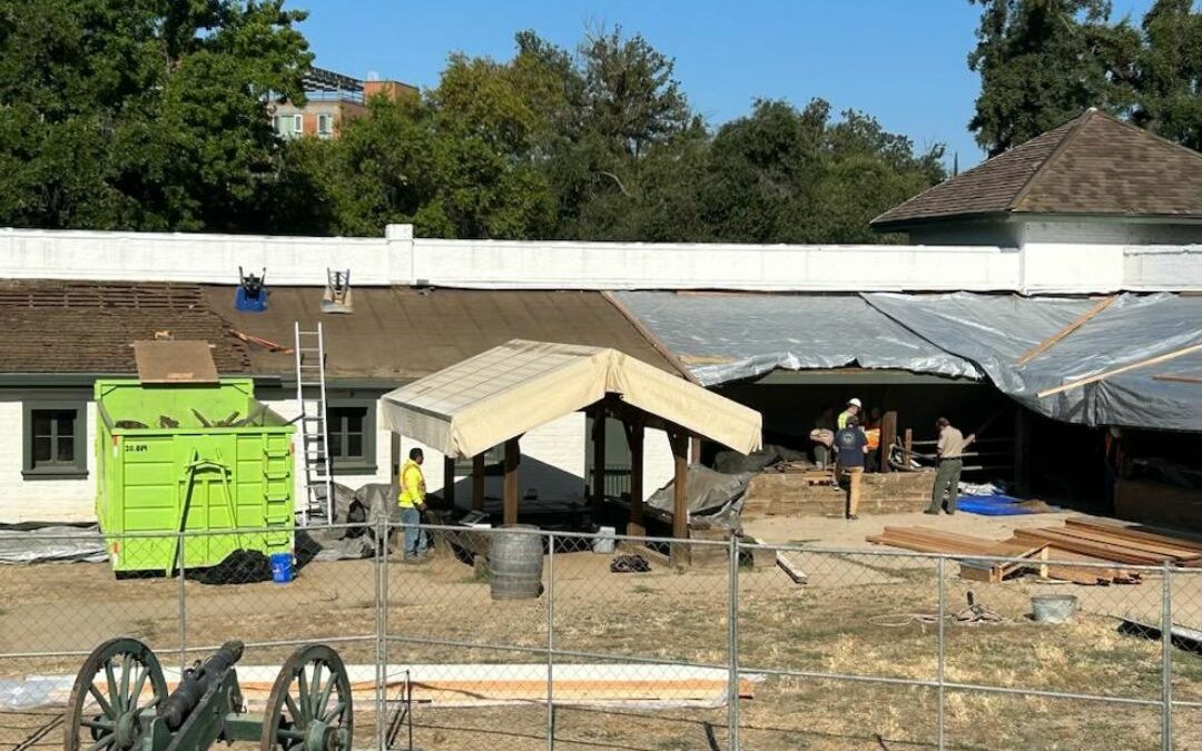 construction on the western section of Sutter's Fort, tarps over existing roof.