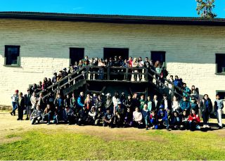 A large group of students gather in front of the Central Building at Sutter's Fort