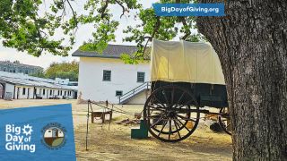 Big Day of Giving Logo, Covered Wagon and Oak Tree with White Brick Building in background